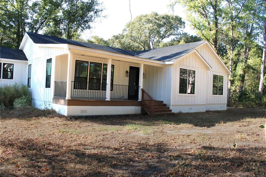 Modern farmhouse style home featuring crawl space, a porch, roof with shingles, and board and batten siding