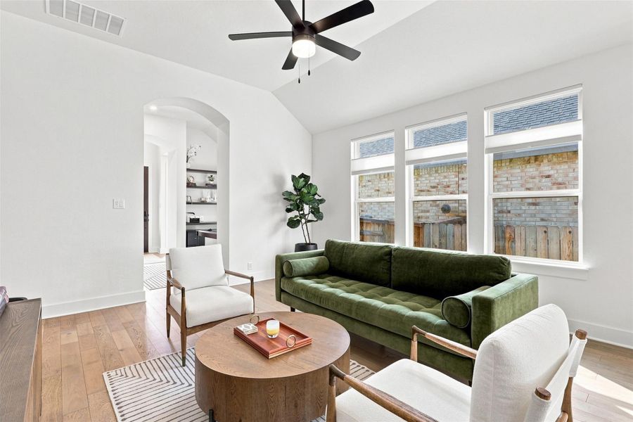 High vaulted ceilings and rich hardwood flooring define this welcoming living space.