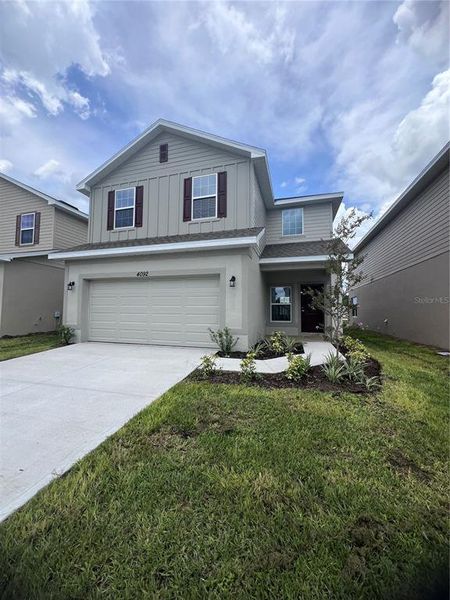 Front exterior of a new home in Harmony Central, Harmony, FL, highlighting curb appeal (Image 12).