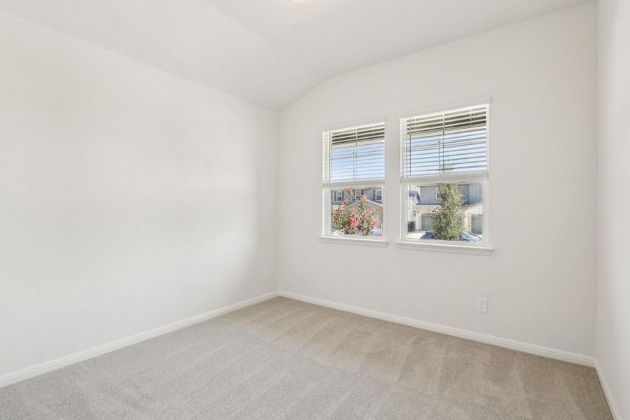 Unfurnished room with carpet and vaulted ceiling Unfurnished room with carpet and vaulted ceiling