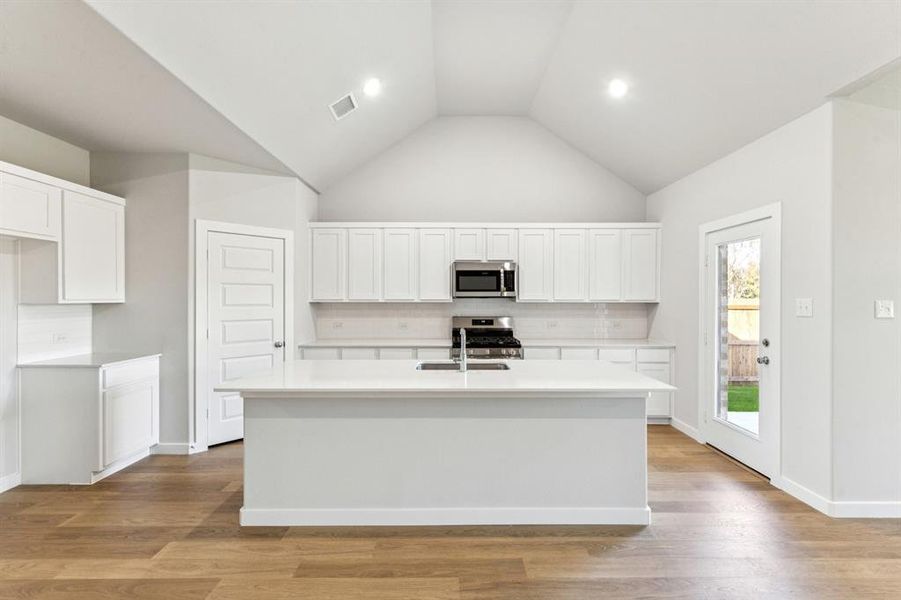Kitchen in the Wimbledon home plan by Trophy Signature Homes – REPRESENTATIVE PHOTO