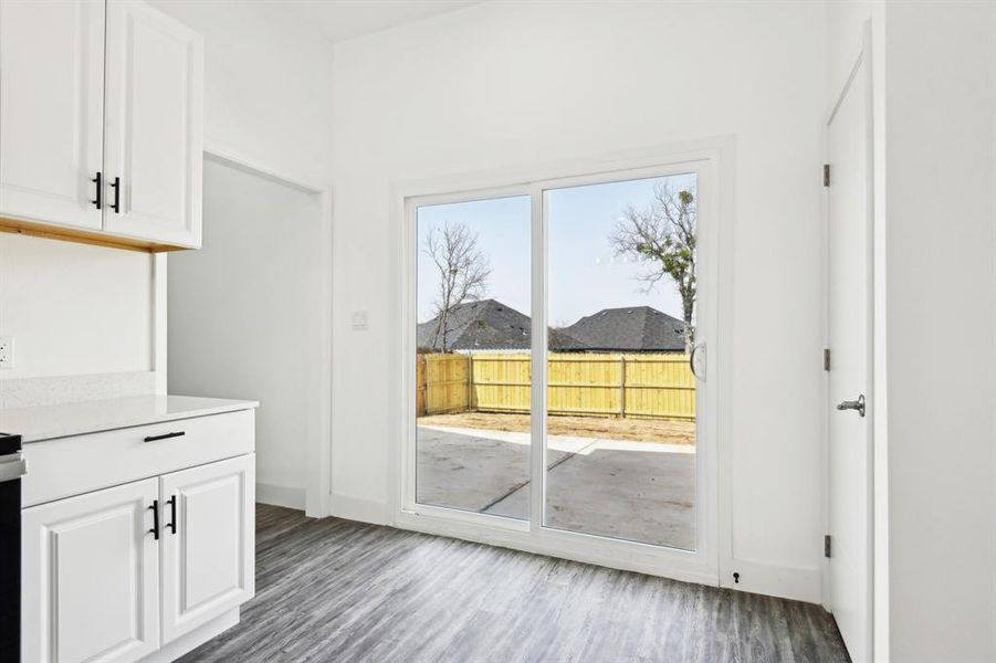 Doorway to outside with baseboards and wood finished floors