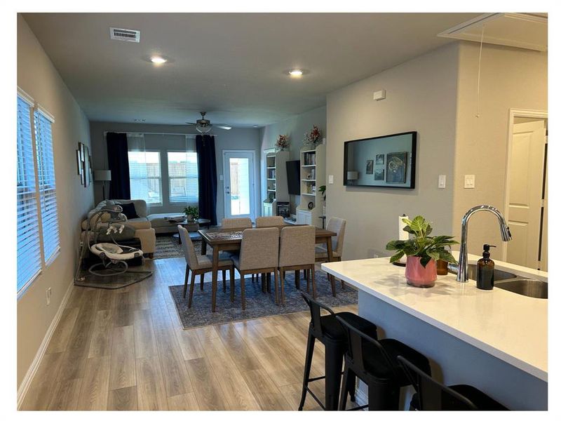 Dining room with ceiling fan, sink, and light hardwood / wood-style flooring