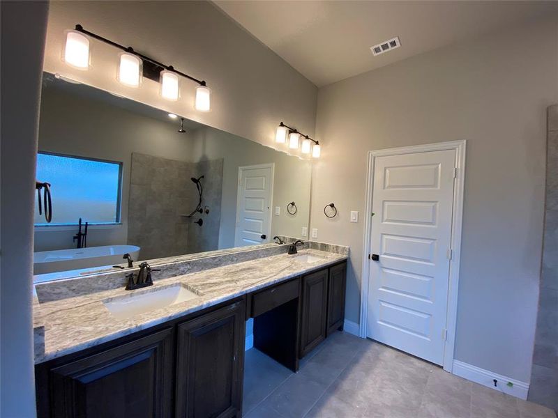 Dual vanity with Fantasy Brown granite and Bronze fixtures