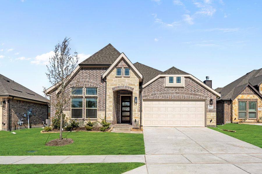 Single-story brick and stone home with two-car garage, arched entry, and manicured front lawn. Single-story brick and stone home with two-car garage, arched entry, and manicured front lawn.