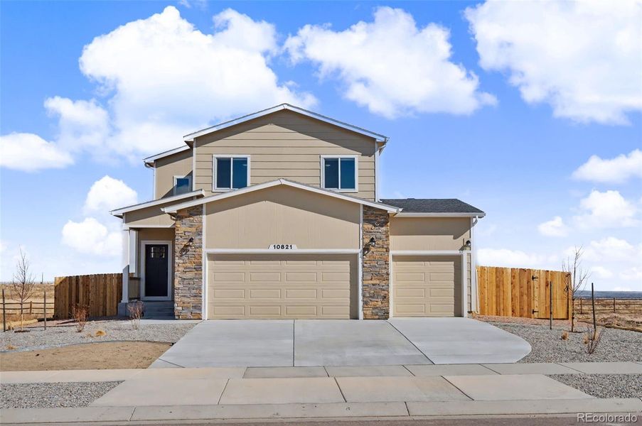 Front exterior of a new home in , Peyton, CO, highlighting curb appeal (Image 27). Front exterior of a new home in , Peyton, CO, highlighting curb appeal (Image 27).