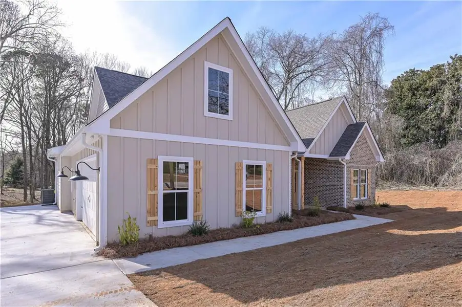 Front exterior of a new home in , Temple, GA, highlighting curb appeal (Image 1). Front exterior of a new home in , Temple, GA, highlighting curb appeal (Image 1).