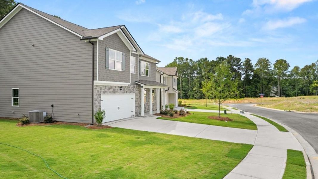 Front exterior of a new home in Northwoods at Mirror Lake, Villa Rica, GA, highlighting curb appeal (Image 21).
