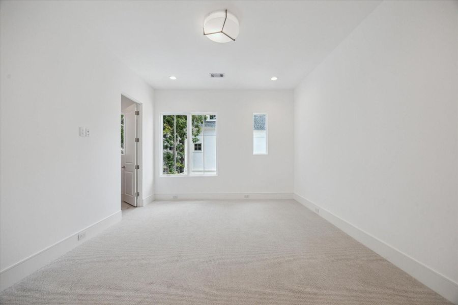 Second-floor bedroom receives ample natural light and features a  Dreamweaver Pinpoint high-performance carpet and AFX LumaFuse light fixture with  laminated fabric/acrylic shade.