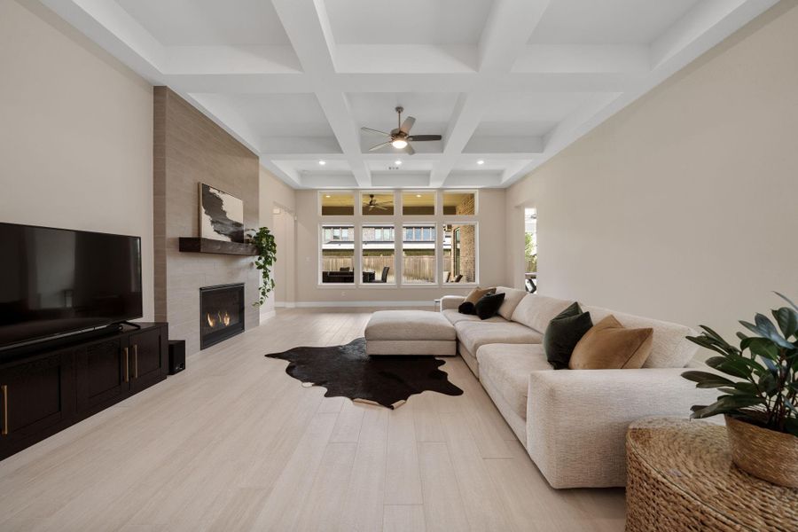 Large windows flood the room with natural light, offering a view of the serene backyard. The clean, light-colored tile flooring complements the neutral palette, creating a soothing atmosphere. Large windows flood the room with natural light, offering a view of the serene backyard. The clean, light-colored tile flooring complements the neutral palette, creating a soothing atmosphere.