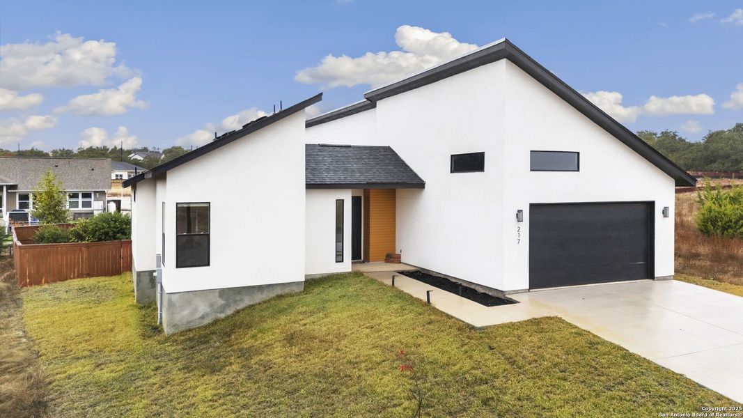 Front exterior of a new home in , Blanco, TX, highlighting curb appeal (Image 25).