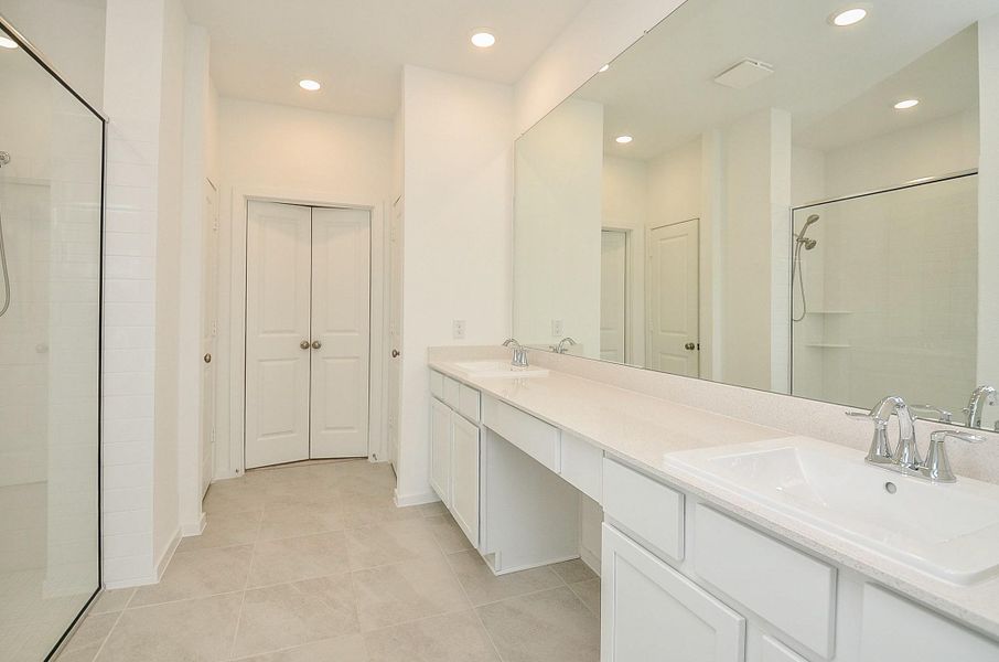 Primary en suite bathroom with double sinks, vanity area, spacious closet and LARGE walk in shower