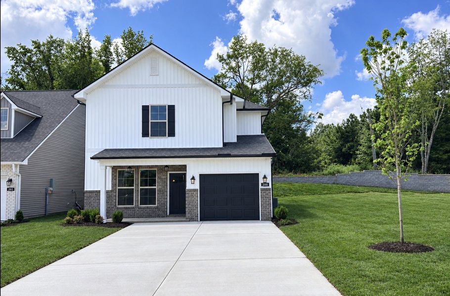 Front exterior of a new home in Hickory Cove, Burns, TN, highlighting curb appeal (Image 16). Front exterior of a new home in Hickory Cove, Burns, TN, highlighting curb appeal (Image 16).