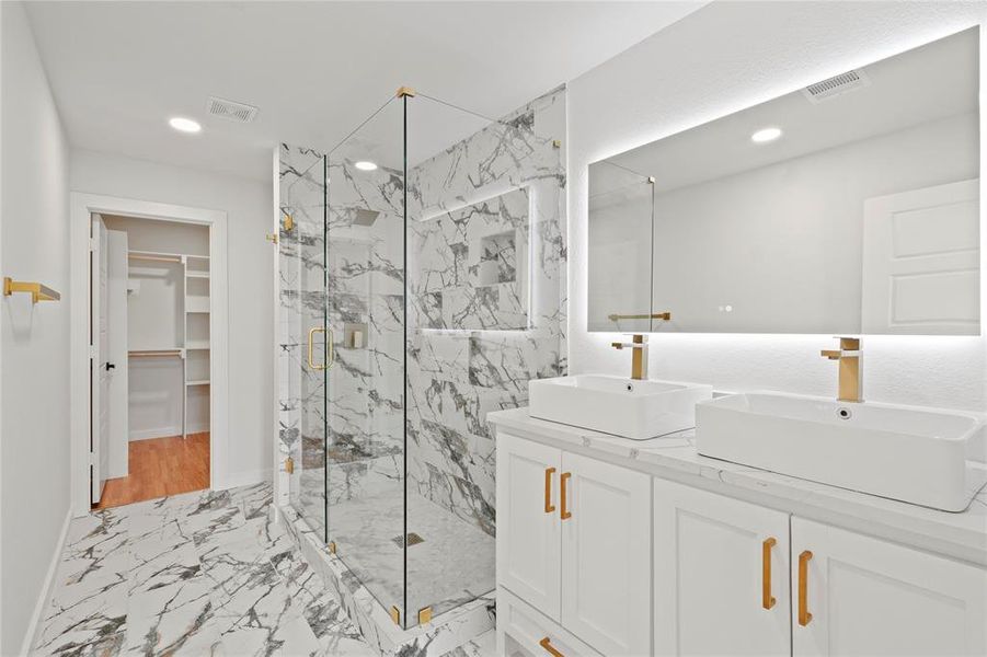 Bathroom with an enclosed shower and vanity