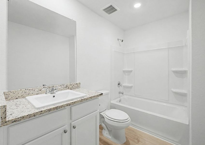 Secondary bathroom with a dual shower and tub.