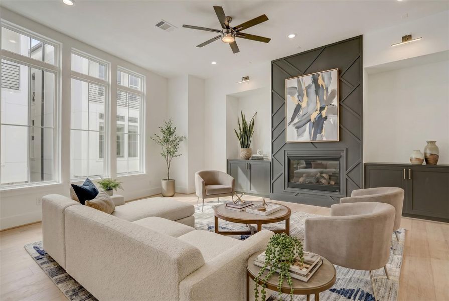 The second floor living area is showered in natural light and offers magnificent focal points and size. Virtually staged photo.