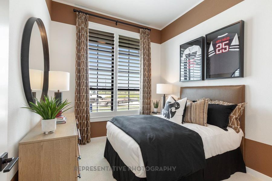 Carpeted bedroom with baseboards and crown molding Carpeted bedroom with baseboards and crown molding