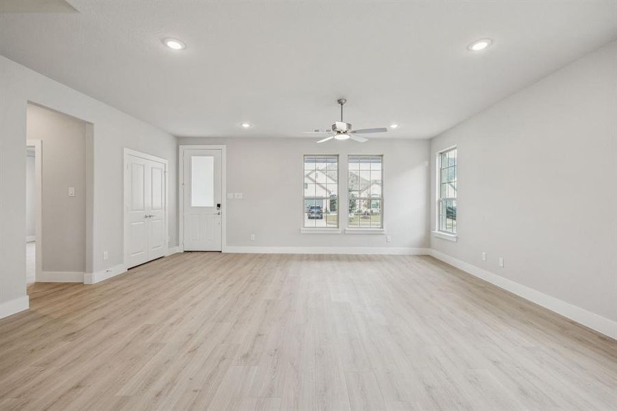 Unfurnished living room featuring light wood-style flooring, recessed lighting, and a ceiling fan Unfurnished living room featuring light wood-style flooring, recessed lighting, and a ceiling fan