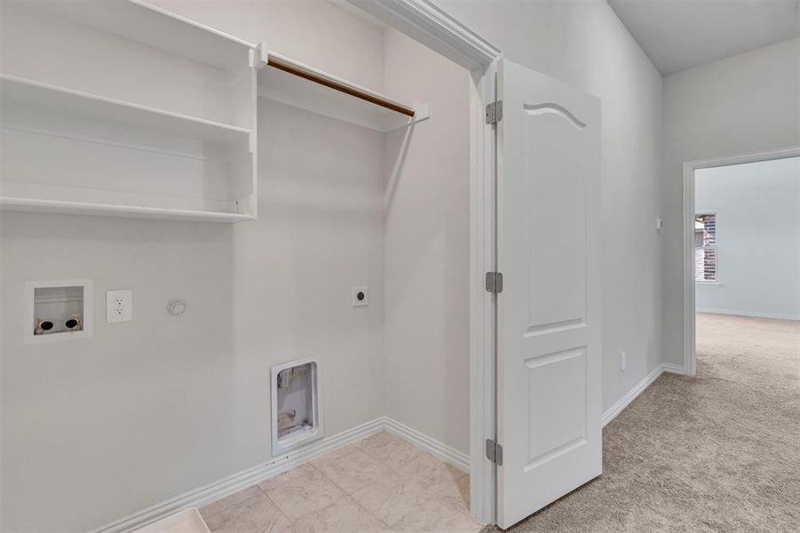 Laundry room with hookup for a washing machine, light carpet, electric dryer hookup, and hookup for a gas dryer