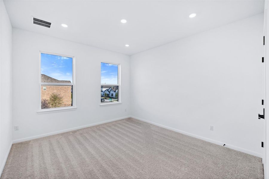 Carpeted empty room featuring baseboards and recessed lighting
