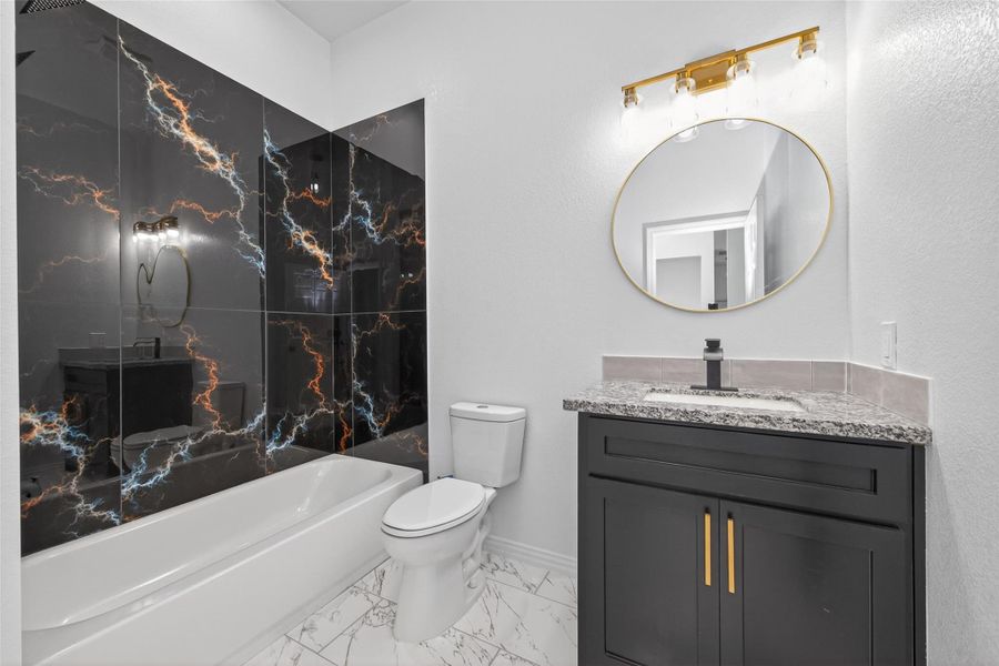Beautiful secondary bathroom showcasing custom cabinetry and modern design details.