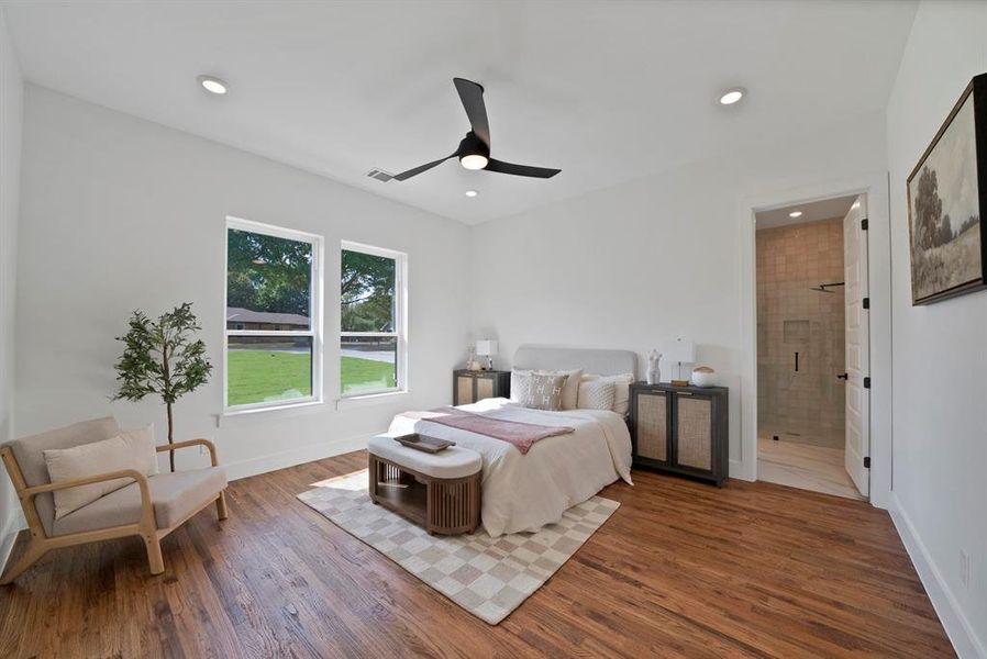 Bedroom featuring ceiling fan, wood finished floors, recessed lighting, and ensuite bathroom Bedroom featuring ceiling fan, wood finished floors, recessed lighting, and ensuite bathroom