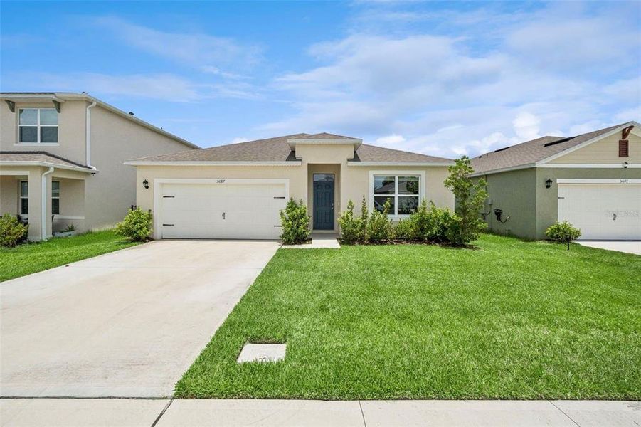 Front exterior of a new home in Buena Lago, St. Cloud, FL, highlighting curb appeal (Image 22).