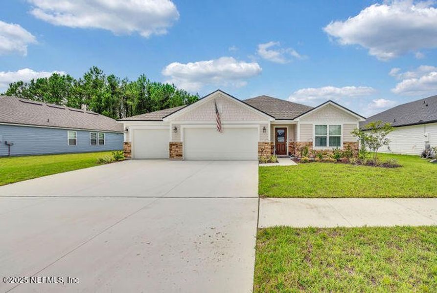 Front exterior of a new home in Edinburgh Village, Jacksonville, FL, highlighting curb appeal (Image 22). Front exterior of a new home in Edinburgh Village, Jacksonville, FL, highlighting curb appeal (Image 22).
