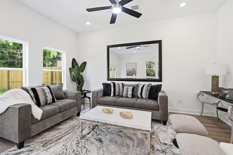Open concept kitchen, dining and living room, with lots of natural light.