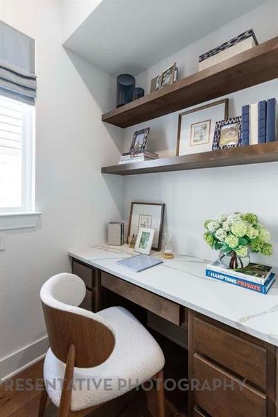 Office space with built in desk and baseboards Office space with built in desk and baseboards