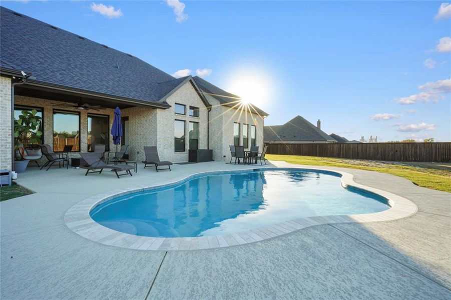 View of pool featuring a patio area, a ceiling fan, and a fenced backyard View of pool featuring a patio area, a ceiling fan, and a fenced backyard