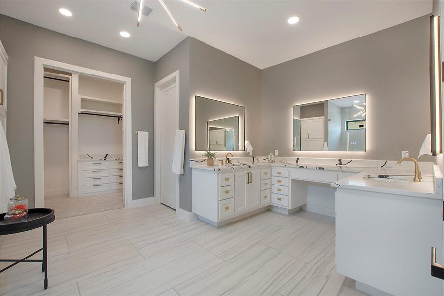 Bathroom featuring tile floors and dual vanity