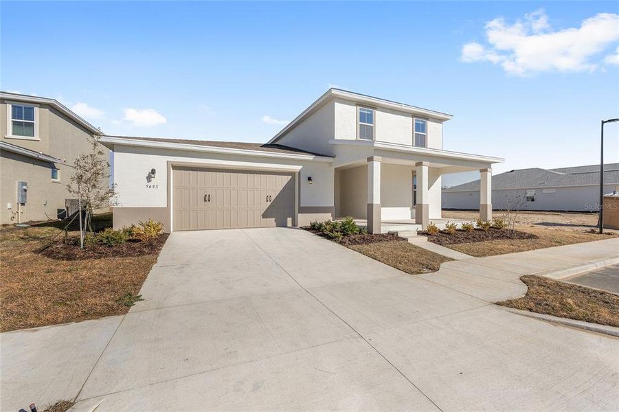 Front exterior of a new home in Calesa Township, Ocala, FL, highlighting curb appeal (Image 22).