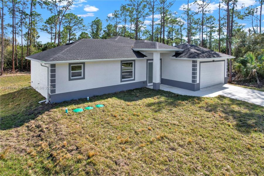 Front exterior of a new home in , Lehigh Acres, FL, highlighting curb appeal (Image 26). Front exterior of a new home in , Lehigh Acres, FL, highlighting curb appeal (Image 26).