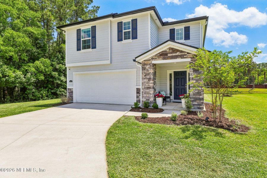 Front exterior of a new home in Dunns Crossing, Jacksonville, FL, highlighting curb appeal (Image 1). Front exterior of a new home in Dunns Crossing, Jacksonville, FL, highlighting curb appeal (Image 1).