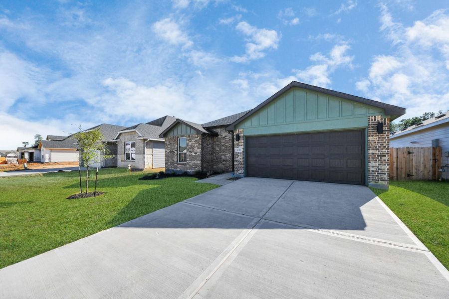 Front exterior of a new home in Grand Oaks Reserve, Cleveland, TX, highlighting curb appeal (Image 25). Front exterior of a new home in Grand Oaks Reserve, Cleveland, TX, highlighting curb appeal (Image 25).
