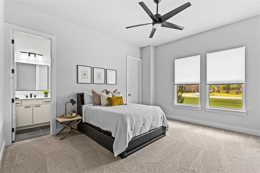 Bedroom featuring carpet flooring, a ceiling fan, and ensuite bathroom