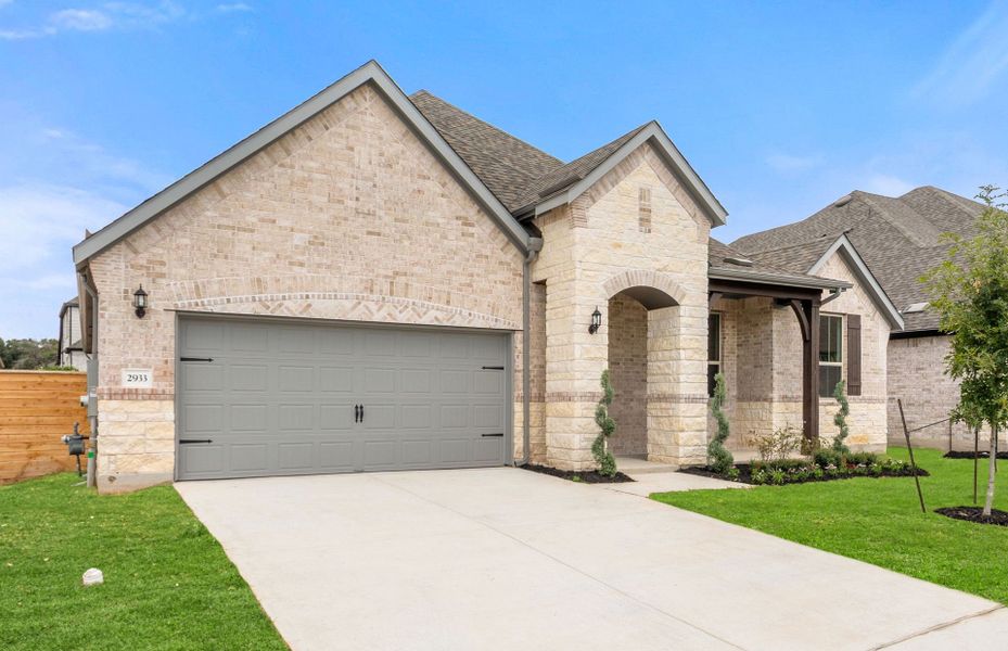 Front exterior of a new home in Bluffview Reserve, Leander, TX, highlighting curb appeal (Image 24).