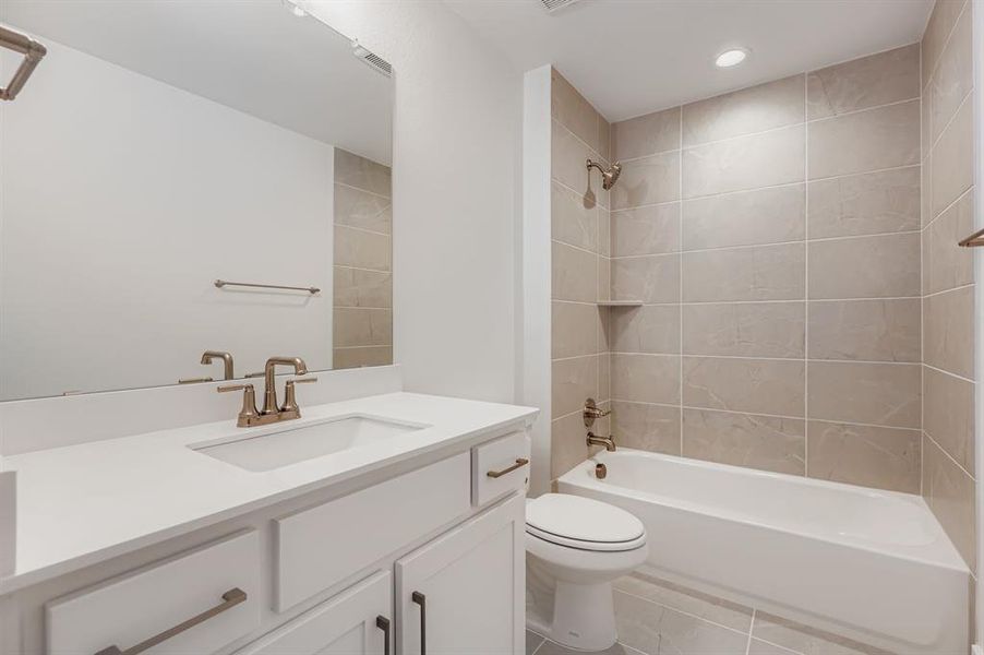 Full bath with bathing tub / shower combination, vanity, light tile patterned flooring, and recessed lighting