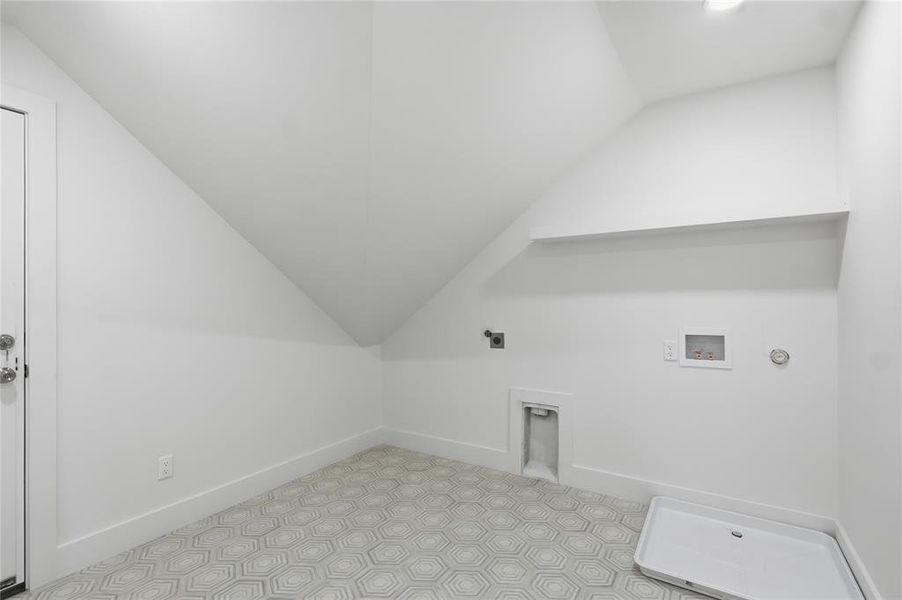 Laundry area featuring geometric patterned floor tiles, white baseboards, a utility sink rough-in, and a built-in shelf