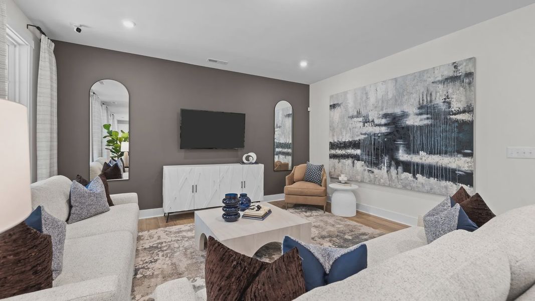 Large Family room with elevated ceiling and large windows in the Jordan Design by DRB Homes in York, SC