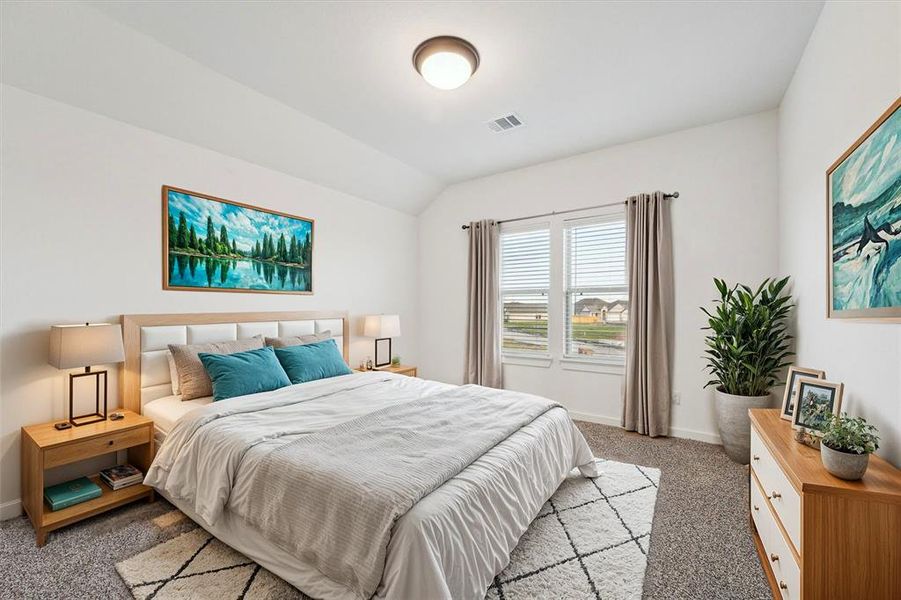 This serene bedroom offers a peaceful retreat, with a large window inviting in natural light and a view of the surrounding neighborhood. The soft color palette and thoughtful decor create a cozy, welcoming atmosphere.