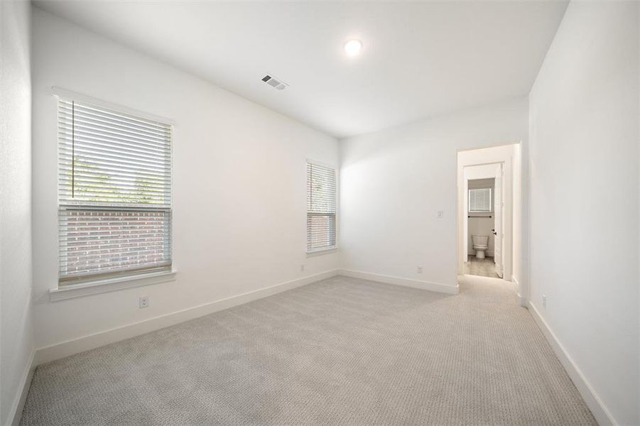 Unfurnished room featuring light colored carpet and baseboards