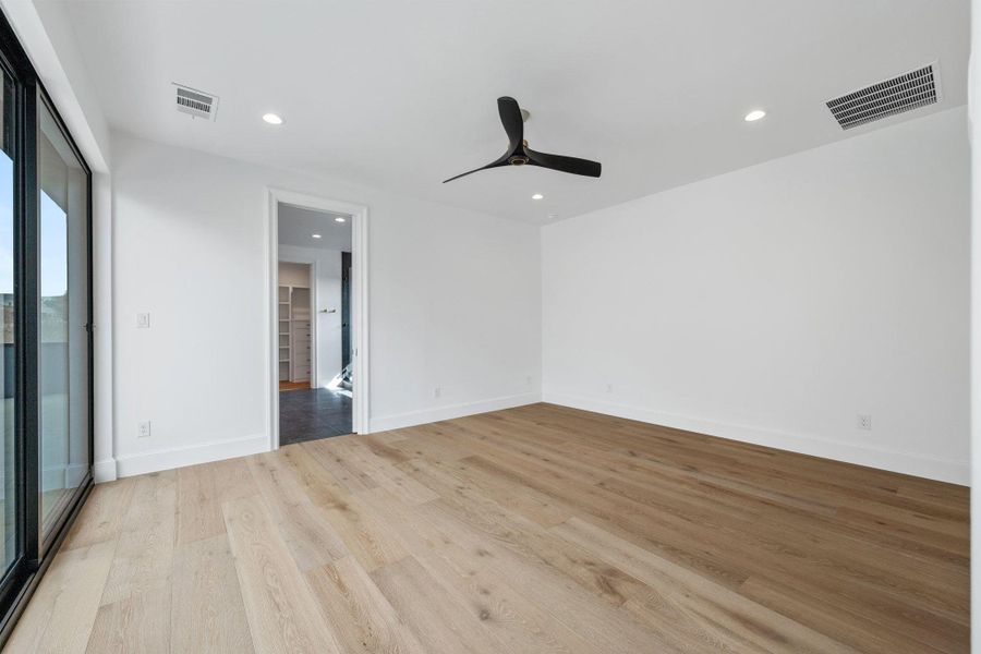 Unfurnished bedroom featuring ceiling fan, light wood-style flooring, access to exterior, and recessed lighting