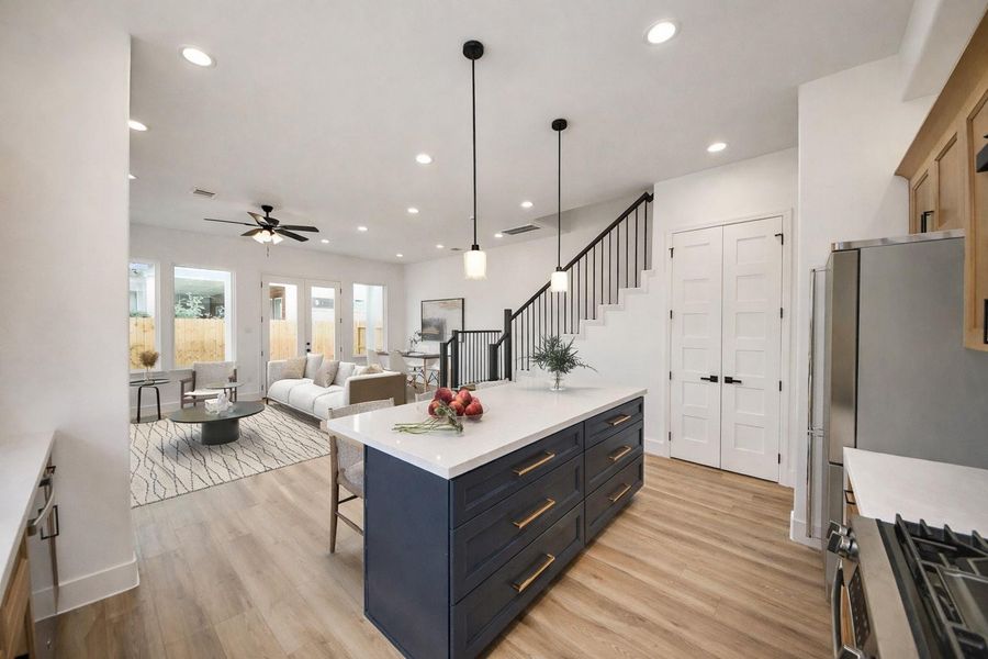 Beautiful kitchen with a large island, ample seating, and warm modern finishes. Open layout and natural light make it perfect for everyday living and entertaining.