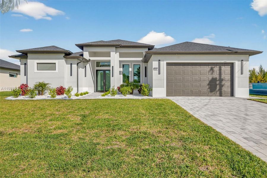 Front exterior of a new home in , Cape Coral, FL, highlighting curb appeal (Image 1).