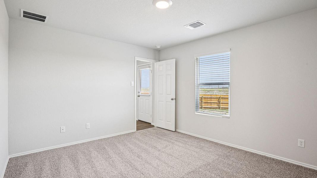 Carpeted room with a single window featuring horizontal blinds Carpeted room with a single window featuring horizontal blinds