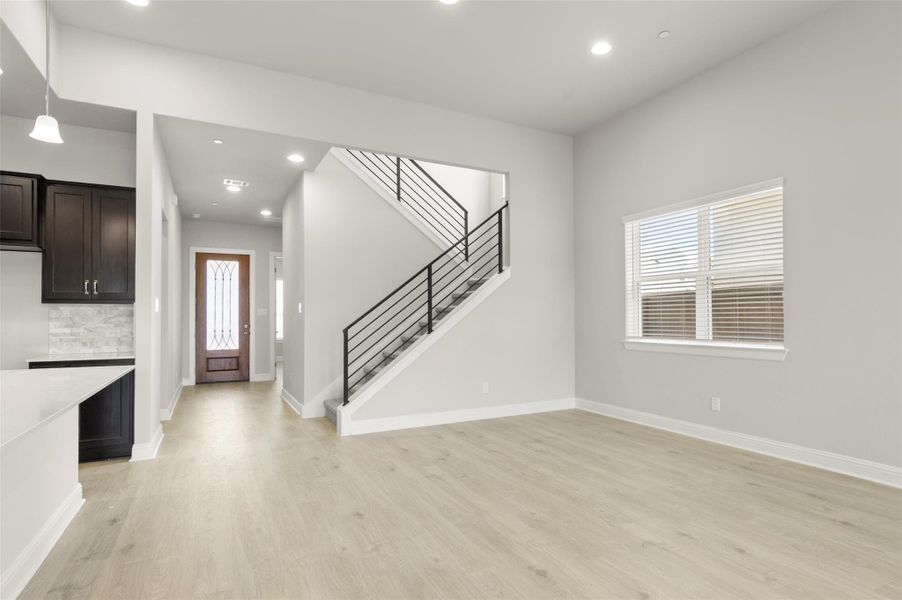 Entrance foyer featuring light wood finished floors, stairs, and recessed lighting Entrance foyer featuring light wood finished floors, stairs, and recessed lighting
