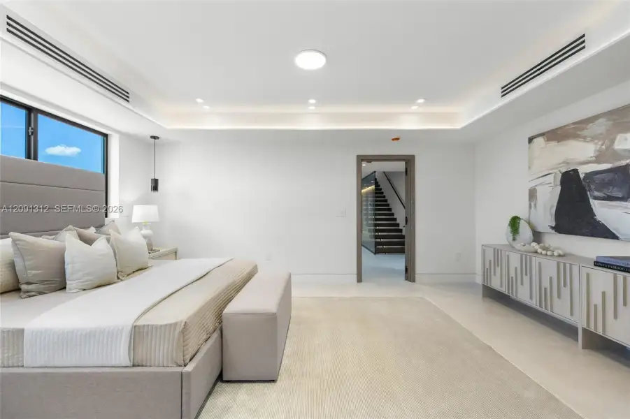 Tray ceiling with integrated lighting, custom built-in cabinetry, and recessed linear HVAC diffusers Tray ceiling with integrated lighting, custom built-in cabinetry, and recessed linear HVAC diffusers