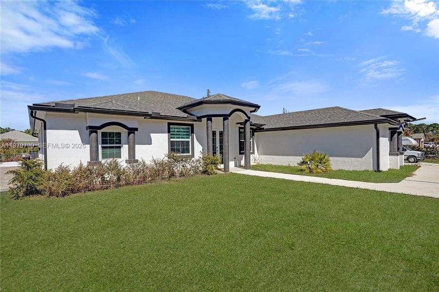 Front exterior of a new home in , Loxahatchee, FL, highlighting curb appeal (Image 34).